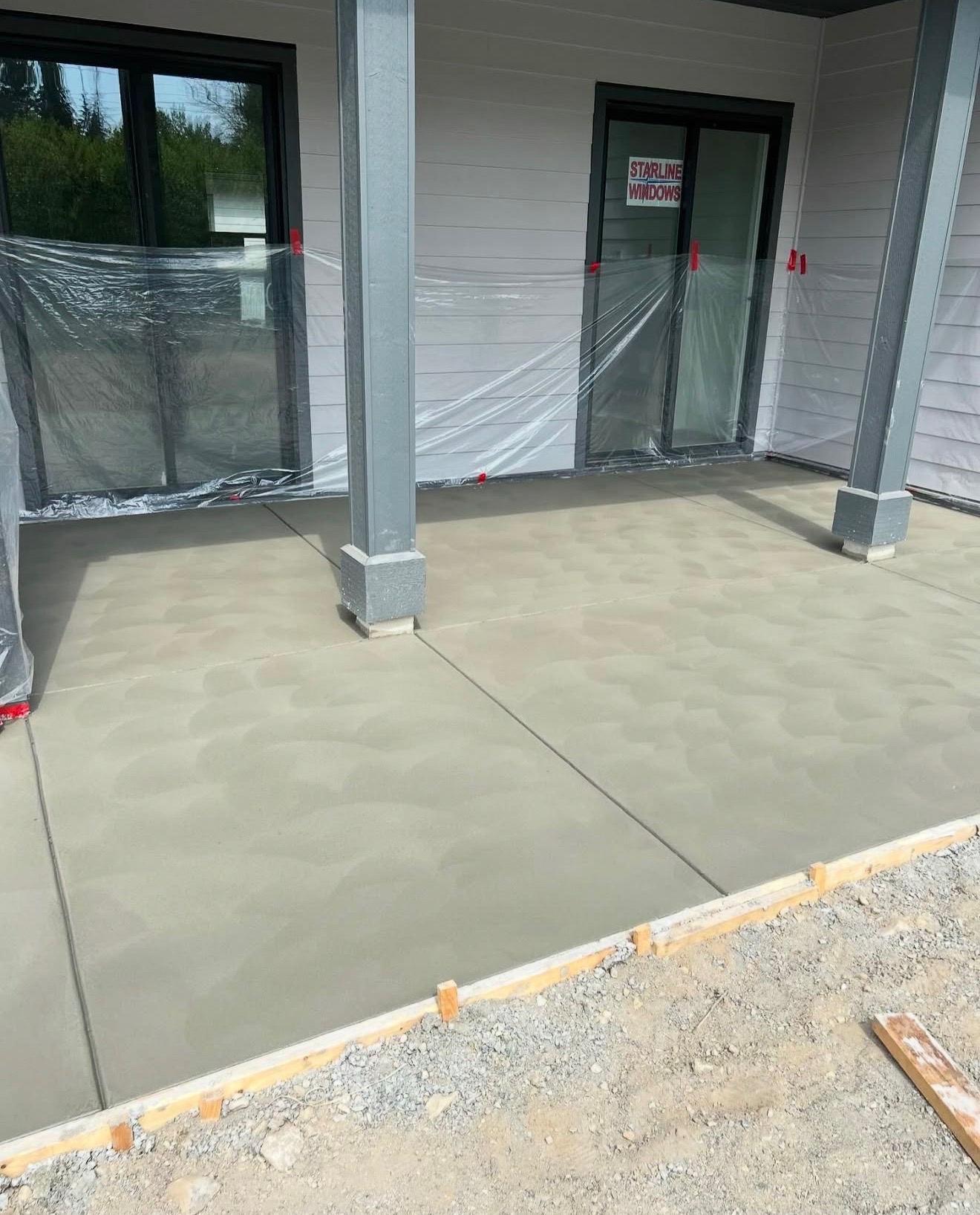 Fresh poured concrete patio with column bases