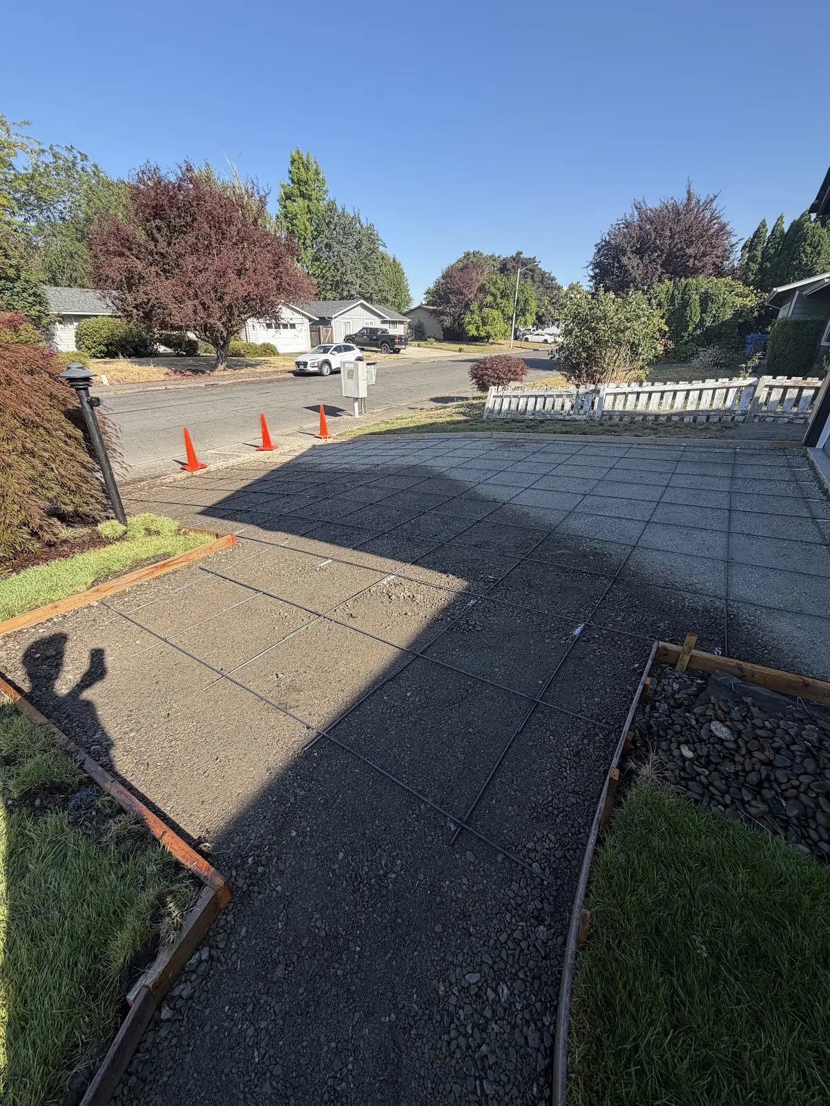 Driveway forms, compacted base, and reinforcement before concrete placement
